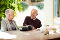 Theres always a reason to smile with you around. an affectionate senior couple enjoying a meal together outdoors. Royalty Free Stock Photo