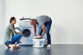 Theres something attractive about men doing chores. a young woman doing laundry at home.