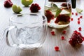 Thermal glass cup with ice and pomegranate tea with apple Royalty Free Stock Photo