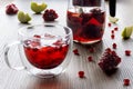 Thermal glass cup with ice and pomegranate tea with apple Royalty Free Stock Photo