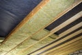 Thermal insulation mineral rock wool installation at the new building attic ceiling Royalty Free Stock Photo