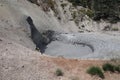 A thermal, muddy pond and cave at yellowstone park.