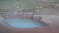 Thermal Pot Steams At The Edge of Grassy Field