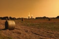 Thermal power plant with green field with hay bales. Royalty Free Stock Photo