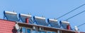 Thermal solar panels and water heater alternative technologies of water heating on the roof of the hotel against the blue sky Royalty Free Stock Photo