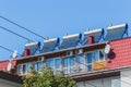 Thermal solar panels and water heater alternative technologies of water heating on the roof of the hotel against the blue sky Royalty Free Stock Photo