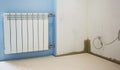 Thermal and sound protection in the interior of the apartment. Gypsum-fiber plates. Plastered walls. White aluminum radiator with