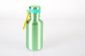 A thermal stainless steel bottle closed travel thermos mock up green design template of packaging mockup on white background