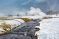 Thermal steam rises from hot water in Yellowstone in winter