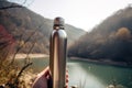 Thermo bottle hand hiking. Generate Ai