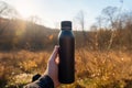 Thermo bottle hand nature. Generate Ai