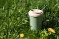Thermo glass, thermo mug on green grass. Concept: less plastic, sustainable, recyclable.