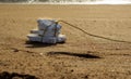 Thermocol Fishnet Float on beach sand with background sea waves Royalty Free Stock Photo