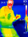 A thermographic image of a person`s body showing different temperatures in different colors, from blue indicating cold to red