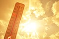 Thermometer against background hot, summer yellow sun.Hot weather and high air temperature. Royalty Free Stock Photo
