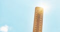 Thermometer with blue sky and sun, measure the temperature, weather forecast, global warming and environment discussion, heat wave Royalty Free Stock Photo