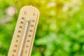 Thermometer with blur green background for cooling air low temperature from plant tree garden Royalty Free Stock Photo