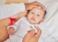 Thermometer, covid and sick baby in bed with parents hand on their forehead checking for fever or flu at home. Worry