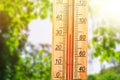 Thermometer displaying high 30 degree hot temperatures in sun summer day. Royalty Free Stock Photo