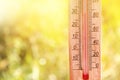 Thermometer displaying high 30 degree hot temperatures in sun summer day. Royalty Free Stock Photo