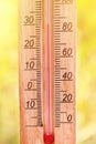 Thermometer displaying high 30 degree hot temperatures in sun summer day