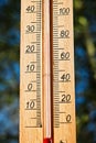 Thermometer displaying high 30 degree hot temperatures in sun summer day Royalty Free Stock Photo