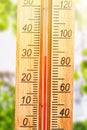 Thermometer displaying high 30 degree hot temperatures in sun summer day Royalty Free Stock Photo