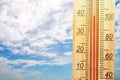 Thermometer displaying high 40 degree hot temperatures in sun summer day. Royalty Free Stock Photo