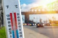 Thermometer in front of cars and traffic during heatwave Royalty Free Stock Photo