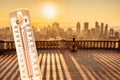 Thermometer in front of Montreal skyline during heatwave