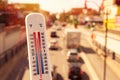 Thermometer in front of cars and traffic Royalty Free Stock Photo