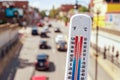 Thermometer in front of cars and traffic Royalty Free Stock Photo
