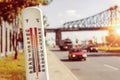 Thermometer in front of cars and traffic during heatwave Royalty Free Stock Photo