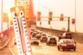 Thermometer in front of cars and traffic during heatwave Royalty Free Stock Photo