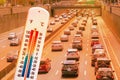 Thermometer in front of cars and traffic during heatwave Royalty Free Stock Photo