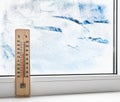 Thermometer on a frozen window and cold weather Royalty Free Stock Photo