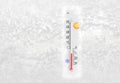 Thermometer on a frozen window shows minus 9 degrees celsius temperature in cold winter day Royalty Free Stock Photo