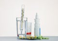 Thermometer in a glass of water and medication for the table Royalty Free Stock Photo
