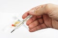 Thermometer in hand Royalty Free Stock Photo