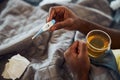 Thermometer in hands of a man drinking tea Royalty Free Stock Photo