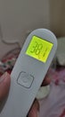 thermometer with high fever 38 celcius yellow lamp and background