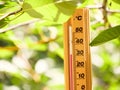 Red heat warning , Heatwave cause climate change and global warming . Mercury wooden weather Thermometer Royalty Free Stock Photo