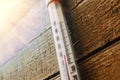 Thermometer on the old wooden wall, concept of autumn cool weather. Royalty Free Stock Photo