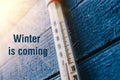 Thermometer on the old wooden wall, concept of winter cold weather. Royalty Free Stock Photo