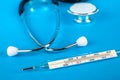 Thermometer and phonendoscop on a blue background Royalty Free Stock Photo