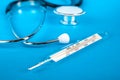 Thermometer and phonendoscop on a blue background Royalty Free Stock Photo