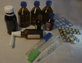 Thermometer, pills and medicine vials Royalty Free Stock Photo