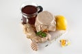 Thermometer, pills and vitamins VS jar of honey , tea, ginger, lemon Royalty Free Stock Photo