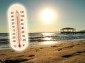 Thermometer showing the temperature rise in the summer sun and seaside photo koncept