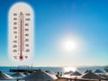 Thermometer showing the temperature rise in the summer sun and seaside photo koncept
